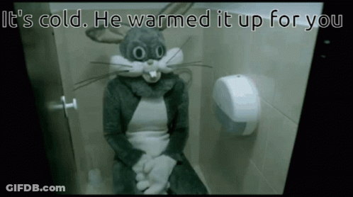 A Person In A Bugs Bunny Costume Is Sitting On A Toilet With The Caption It 'S Cold He Warmed It Up For You GIF