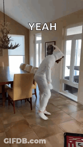 A Person In A Bunny Costume Is Dancing In A Dining Room With A Caption That Says " Yeah " GIF