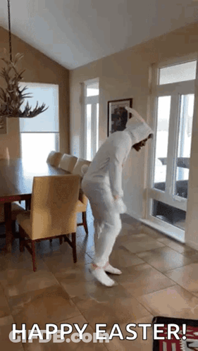 A Person In A Bunny Costume Is Dancing In A Living Room With The Words Happy Easter Written Below It GIF
