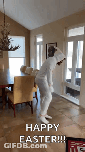 A Person In A Bunny Costume Is Dancing In A Room With The Words Happy Easter Written On The Bottom GIF