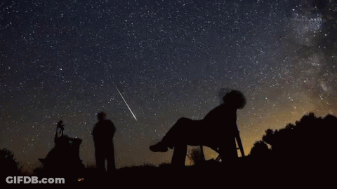 Person Looking At Shooting Star In Chair GIF