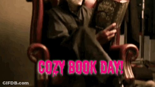 A Person In A Chair Reading A Book With The Words Cozy Book Day In Pink GIF
