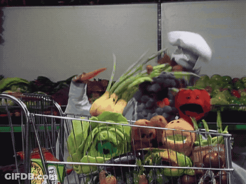 A Person In A Chef 'S Hat Pushes A Shopping Cart Full Of Vegetables GIF