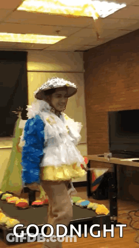 A Person In A Costume Says Goodnight In Front Of A Tv GIF