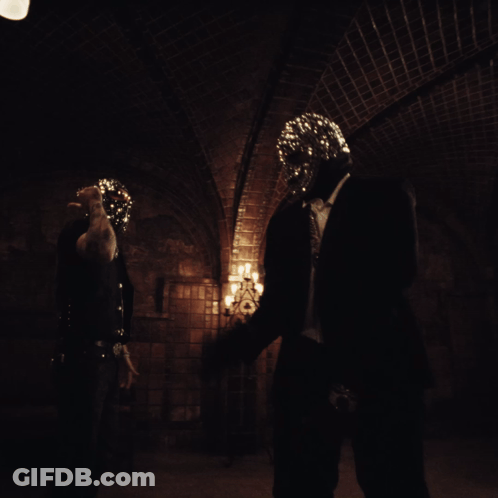 A Person In A Dark Room With A Mask On GIF