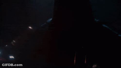 A Person In A Dark Room With A Red Light Coming Out Of Their Mouth GIF