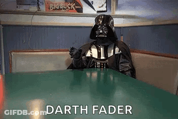 A Person In A Darth Vader Costume Is Sitting At A Table . GIF