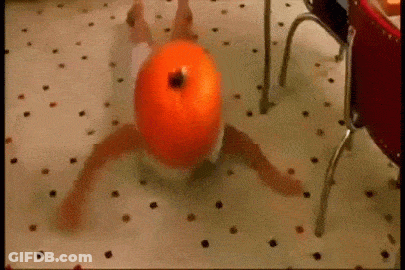A Person In A Diaper Is Laying On The Floor With A Pumpkin On Their Head . GIF