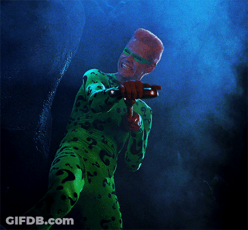 A Person In A Green Costume With A Question Mark On The Back GIF