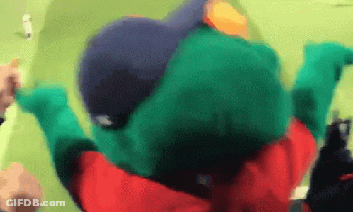 A Person In A Green Frog Costume Is Laying On The Ground GIF