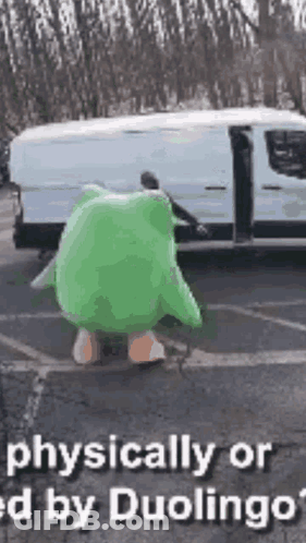 A Person In A Green Frog Costume Is Standing In Front Of A Van . GIF