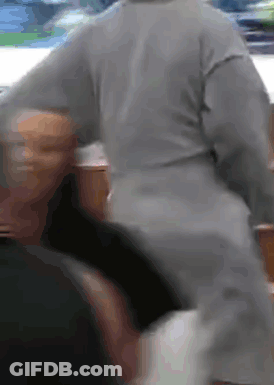 A Person In A Grey Sweater Is Standing Next To Another Person In A Black Shirt . GIF