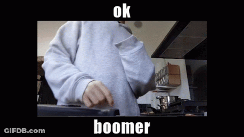 A Person In A Grey Sweatshirt Is Cooking In A Kitchen And The Caption Says Boomer GIF