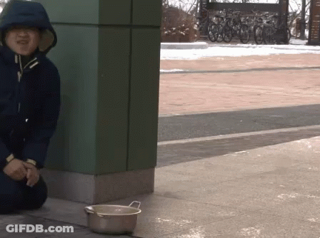 Person In Hooded Jacket Sitting Next To Bowl GIF