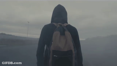 A Person In A Hooded Jacket With A Backpack GIF