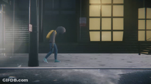 A Person In A Hoodie Is Walking Down A Street GIF