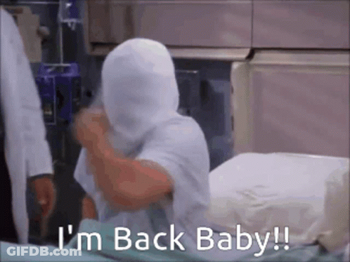 A Person In A Hospital Bed With A Bandage On Their Head And The Words I 'M Back Baby . GIF
