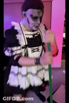 A Person In A Maid Costume Holding A Green Stick GIF