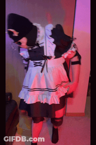 A Person In A Maid Costume Is Standing In A Room With Red Lights GIF