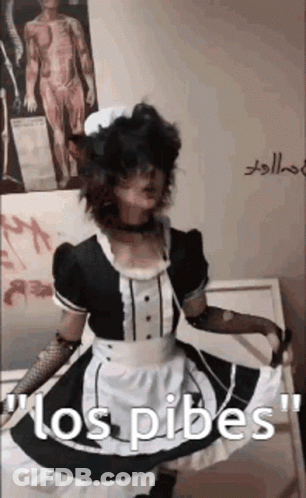 A Person In A Maid Costume Is Standing In Front Of A Wall With A Picture Of A Man On It . GIF