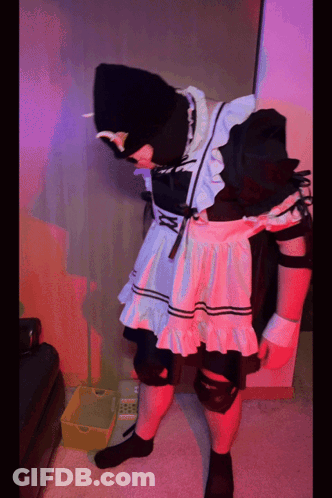 A Person In A Maid Costume Is Standing Next To A Yellow Box GIF