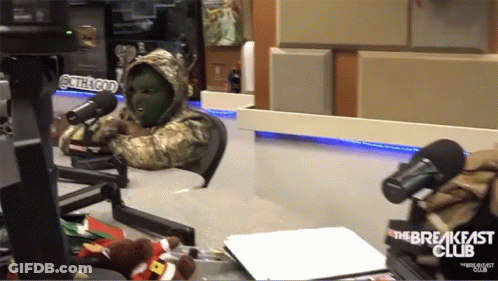 A Person In A Mask Is Sitting In Front Of A Microphone With The Breakfast Club Written On The Bottom GIF