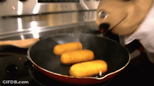 A Person In A Mickey Mouse Costume Is Cooking Food In A Frying Pan GIF