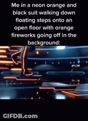 A Person In A Neon Orange And Black Suit Is Walking Down Floating Steps Onto An Open Floor With Orange Fireworks Going O GIF