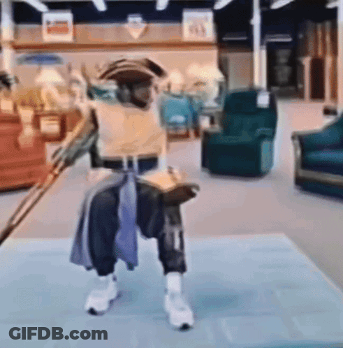A Person In A Pirate Costume Is Holding A Sword In A Living Room GIF