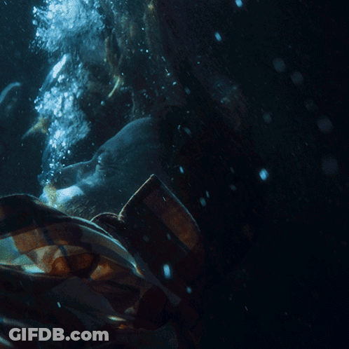 A Person In A Plaid Shirt Is Underwater With Bubbles Coming Out Of Their Mouth GIF