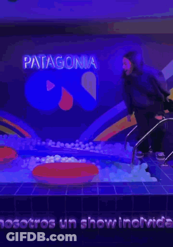 A Person In A Pool With The Word Patagonia On The Wall GIF