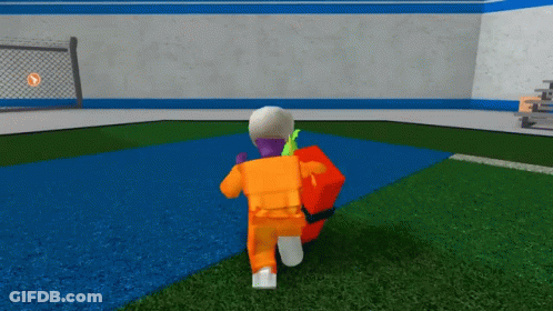 A Person In A Prison Uniform Is Walking On A Field GIF