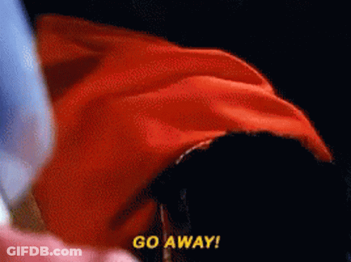 A Person In A Red Cape Says Go Away In Yellow Letters GIF