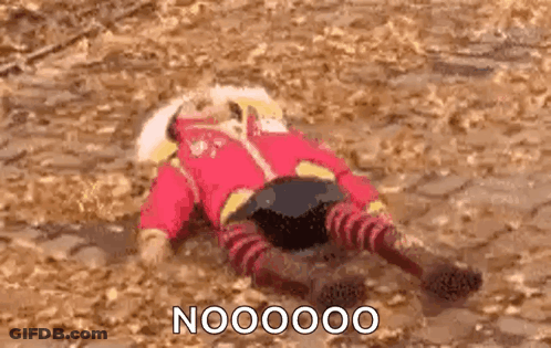 A Person In A Red Jacket And Striped Pants Is Laying On Their Back On The Ground . GIF