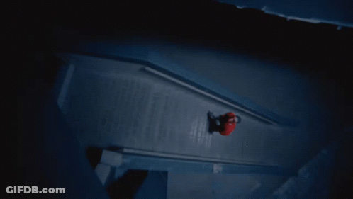 A Person In A Red Shirt Is Walking Down A Dark Staircase GIF