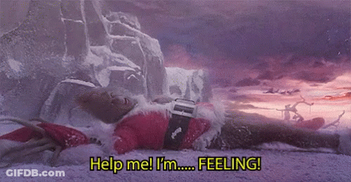 A Person In A Santa Suit Is Laying In The Snow And Says Help Me I 'M Feeling . GIF