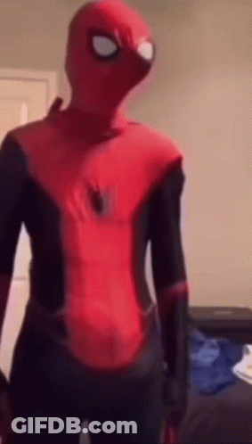 A Person In A Spider Man Costume Is Standing In A Room . GIF