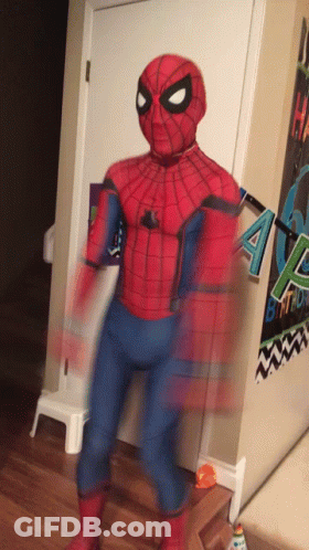 A Person In A Spider Man Costume Is Standing In Front Of A Birthday Banner GIF