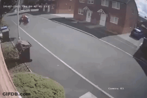 A Person In A Spiderman Costume Is Standing On The Side Of The Road . GIF