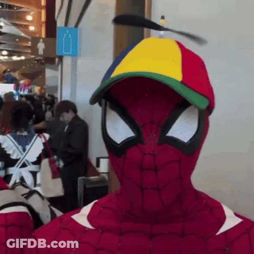 A Person In A Spiderman Costume With A Colorful Hat GIF