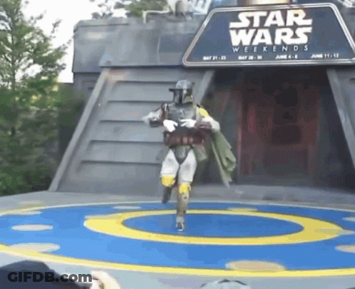 A Person In A Star Wars Costume Is Dancing In Front Of A Star Wars Weekends Sign GIF
