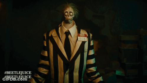 A Person In A Striped Suit Has A Name Tag That Says Hello 808 GIF