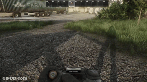 A Person In A Video Game Is Holding A Bullet In Their Hand In Front Of A Truck That Says " Paradox " GIF