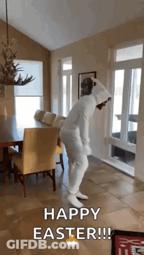 A Person In A White Bunny Suit Is Dancing In A Living Room . GIF