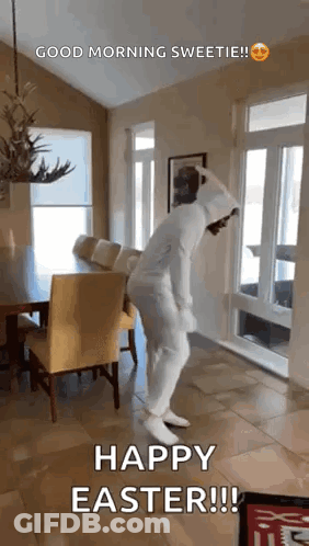 A Person In A White Bunny Suit Is Dancing In A Living Room . GIF