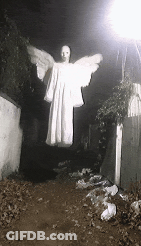 A Person In A White Dress With Wings Is Flying In The Air GIF