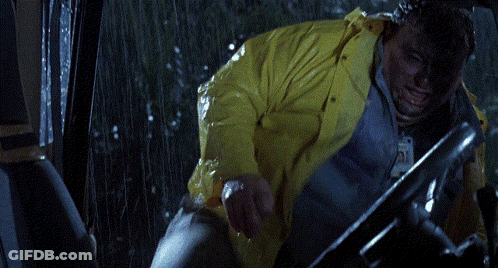 A Person In A Yellow Raincoat Is Driving A Vehicle GIF