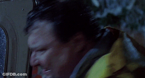 A Person In A Yellow Raincoat Is Standing In The Rain GIF