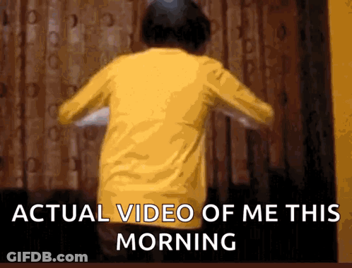 A Person In A Yellow Shirt Is Dancing In Front Of A Window With The Words Actual Video Of Me This Morning GIF
