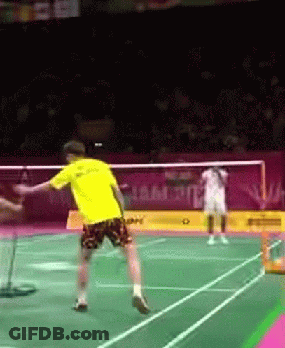 A Person In A Yellow Shirt Is Playing Badminton GIF